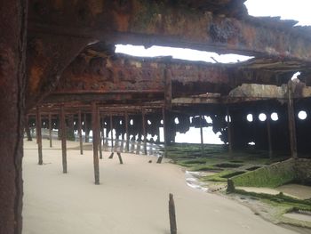 Built structure on beach by illuminated buildings at night