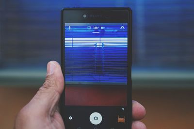 Midsection of man using mobile phone