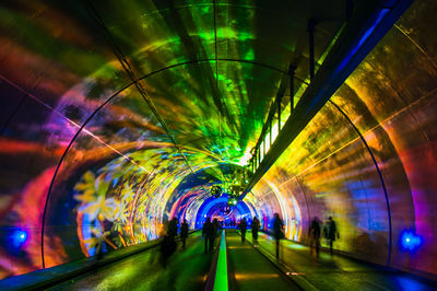 Illuminated tunnel at night
