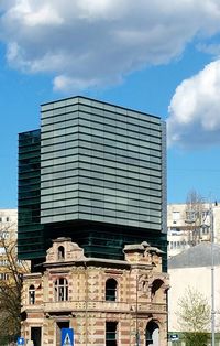 Low angle view of buildings against blue sky