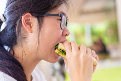 Close-up portrait of a woman eating food
