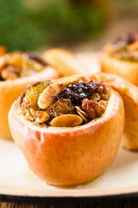 Close-up of apple with dry fruit on table