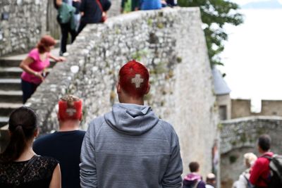 Rear view of men with swiss flag sign