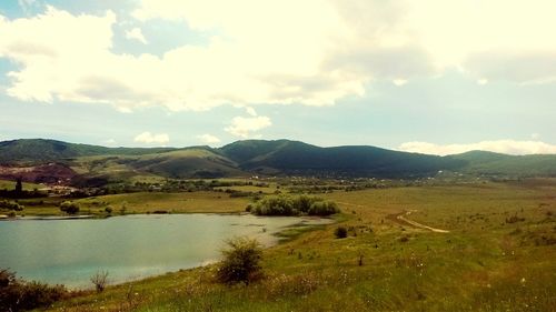 Scenic view of lake and mountains against sky