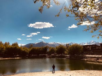 Scenic view of lake by trees against sky