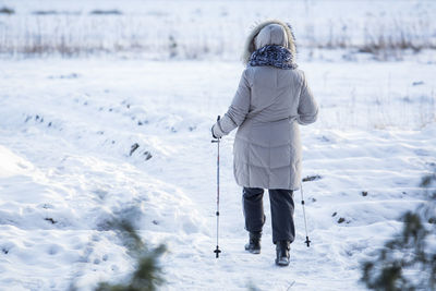 Full length of person standing on snow covered landscape