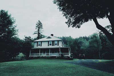 House by trees against sky