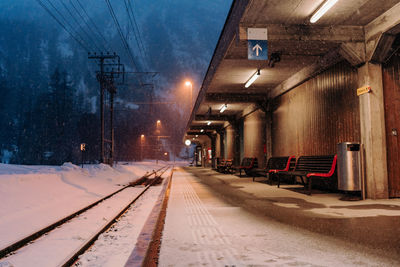 Illuminated railroad station platform during winter