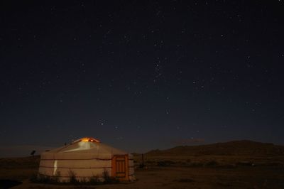 Tent on land against sky at night