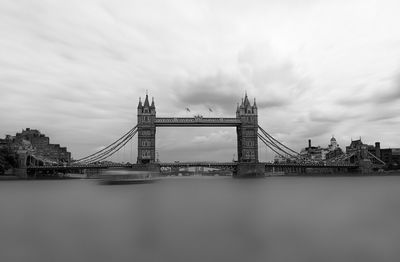 View of suspension bridge against cloudy sky