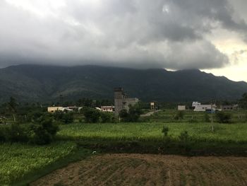 Scenic view of agricultural field against storm clouds