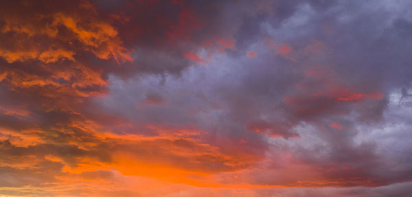 Low angle view of dramatic sky during sunset