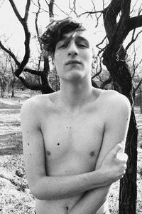 Portrait of young man looking away outdoors