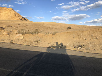 Shadow of man on desert road