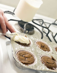 Midsection of person holding cake on table