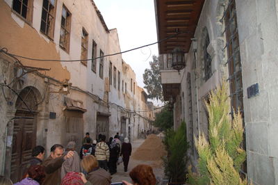 People on street amidst buildings in city