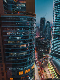 Aerial view of illuminated buildings in city at night