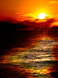 Scenic view of sea against orange sky