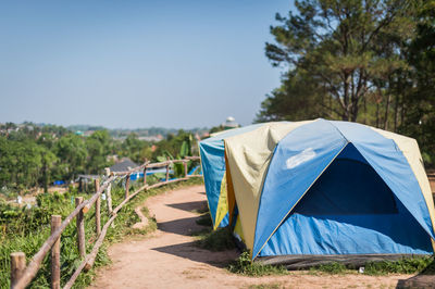 Scenic view of tent against clear blue sky