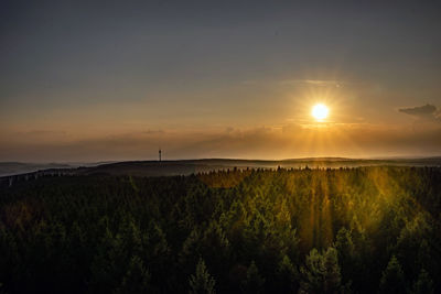 Scenic view of field against sky during sunset