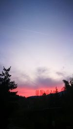 Silhouette trees against sky during sunset