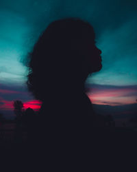 Silhouette woman against sky during sunset