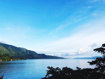 Scenic view of sea against blue sky