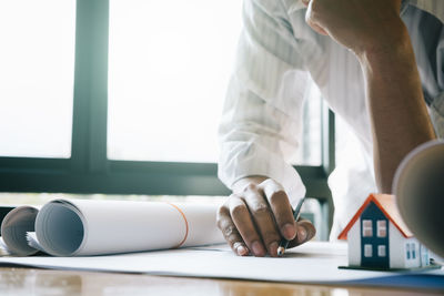 Midsection of man working on table