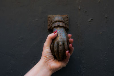 Close-up of hand holding metallic handle