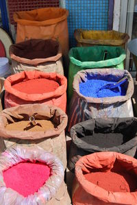 High angle view of colorful powder paints in sack for sale