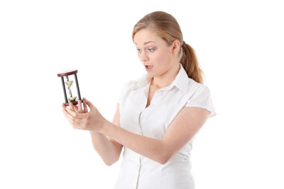 Beautiful young woman wearing hat against white background