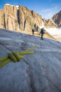 People walking on rock formation