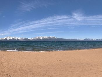 Scenic view of beach against blue sky