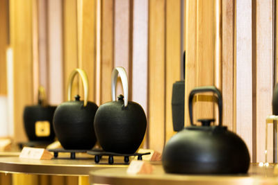 Close-up of antique teapots on table