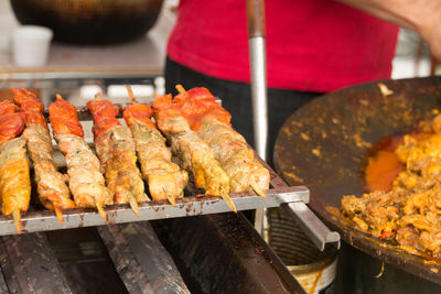 Midsection of vendor with meat at market