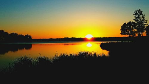 Scenic view of lake against sky during sunset