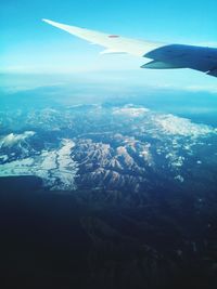 Aerial view of airplane wing over landscape