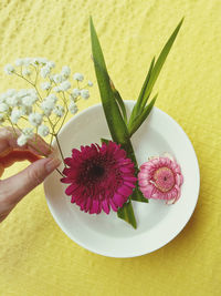  woman holding plant for flower arrangement 