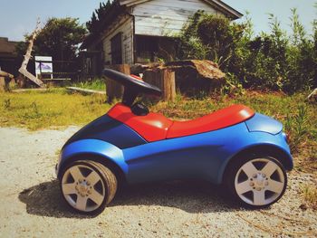 View of toy car on field by house