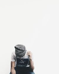 Man photographing against white background