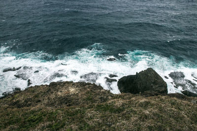 High angle view of rocks in sea