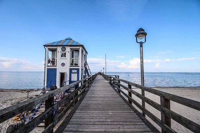 Pier over sea against sky