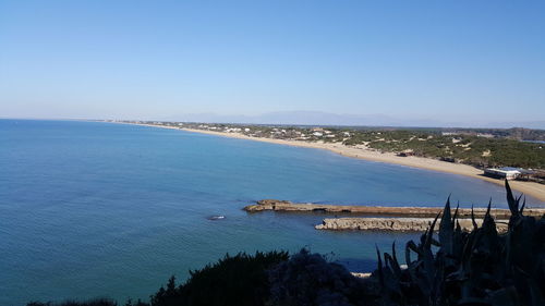 High angle view of sea against clear blue sky