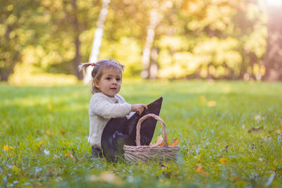 Cute girl sitting on field