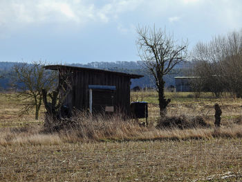 Abandoned building on field against sky