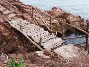 High angle view of wood on rocks at sea shore