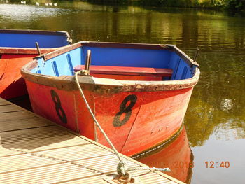 Close-up of red boat moored in lake