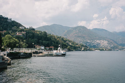 Scenic view of sea and mountains against sky