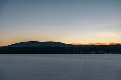 Scenic view of snow against sky during sunset