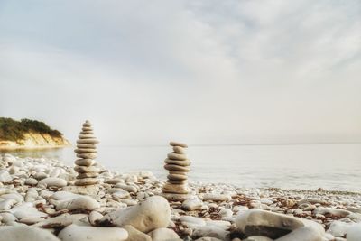 Rocks on beach against sky